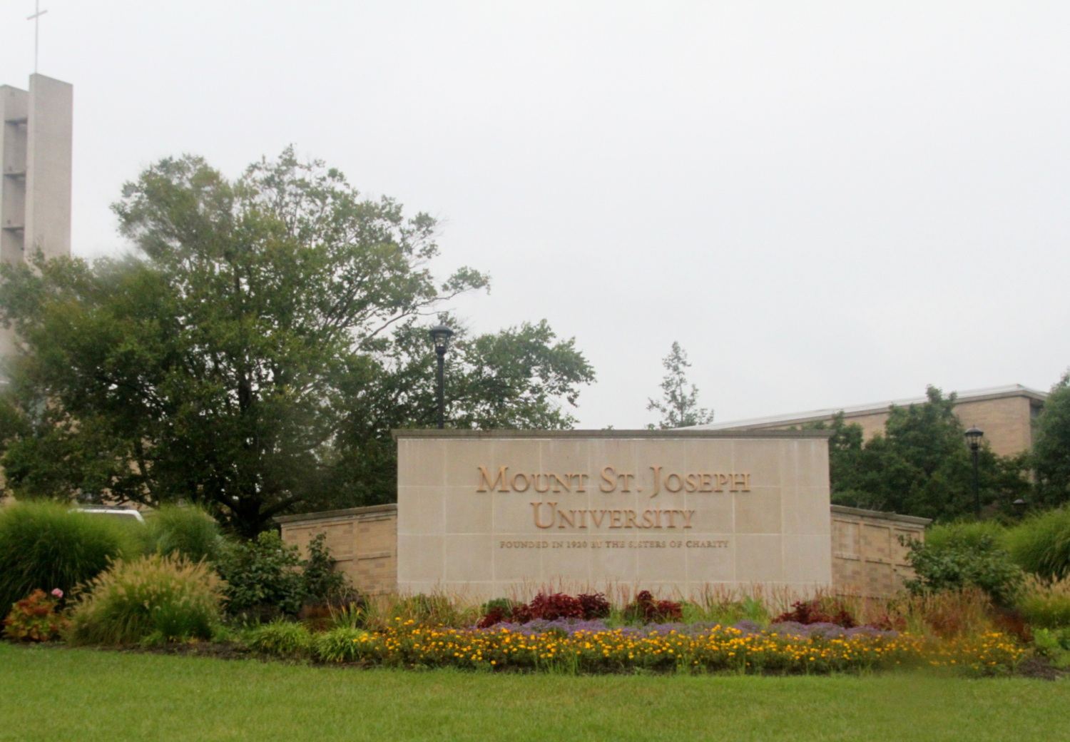 Mount Saint Joseph University sign with flowers.